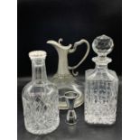 Two cut glass decanters and one port decanter with white metal work base and handle