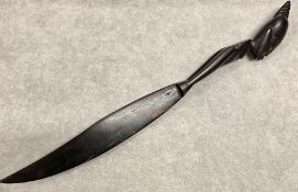 A carved ebonised African letter opener