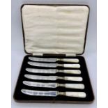 A cased set of six stainless steel and mother of pearl butter knives
