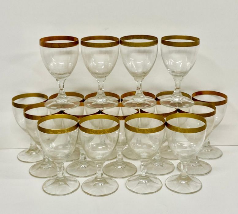 Nineteen wine glasses with gilt rim