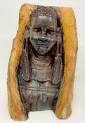 A Kenyan wooden bust of a Maasai women carved into a branch