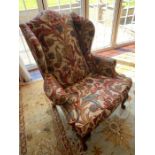 A Fabric covered Wing Back chair 74cm w x 110cm h x seat height 49cm