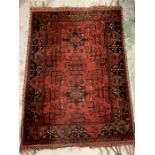 A red grounds rug with two centre squares to middle (153cm x 108cm)