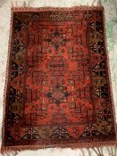 A red grounds rug with two centre squares to middle (153cm x 108cm)