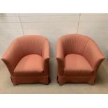 A pair of tub chairs with red upholstery