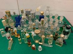 A large selection of perfume bottles of various sizes
