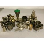 A selection of various pewter items to include, egg cups, salt and pepper pots, napkin rings, etc