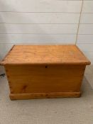 A pine chest with metal handles