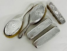 A selection of five silver backed dressing table brushes, hallmarked.