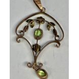 A 9ct gold pendant with peridot central stone and seed pearls.