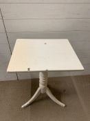 A painted side table on turned centre support