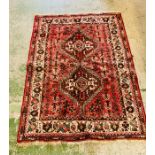 A red, cream and green pattern rug