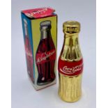 A Coca Cola themed collectable lighter