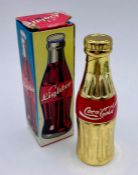 A Coca Cola themed collectable lighter