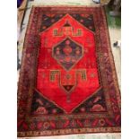 A Hamadon rug with a purple boarder (241cm x 168cm)