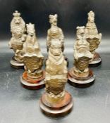 Six large carved chess pieces