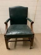 A leather mahogany library chair on castors and stud edging