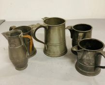 A selection of five pewter jugs