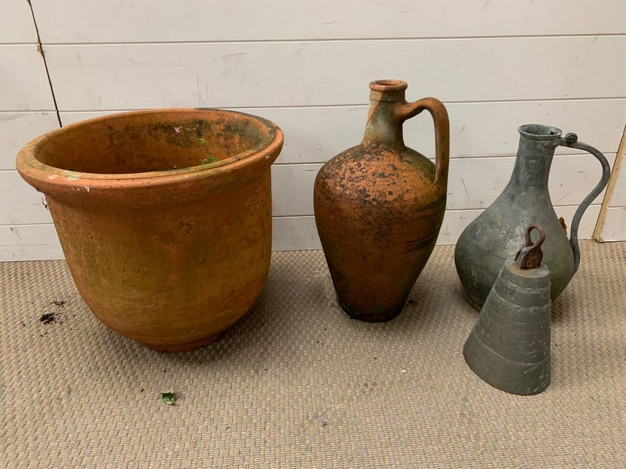 A terracotta urn and plant pot along with a metal jug and bell