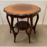 A scrolled edge mahogany two tier table (H67cm Dia68cm)