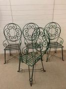 Four reclaimed wrought iron green garden chairs with scroll details to seats