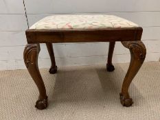 A possibly George II walnut fruitwood stool on ball and claw feet