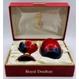 A Royal Doulton Flambe egg and stand in presentation box