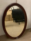 A mahogany oval wall mirror (97cm x 60cm)