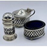 A Three piece silver condiment set with blue glass liners