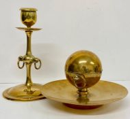 A brass effect inkwell and candlestick