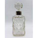 A cut glass scent bottle with silver collar, approx 8" high with stopper. Indistinct hallmarks