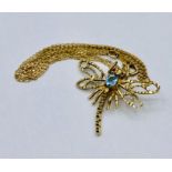 A 9ct gold dragonfly brooch on chain.
