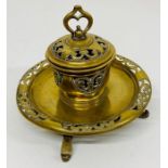 An ornate Victorian brass inkwell