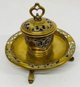 An ornate Victorian brass inkwell