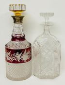 Two cut glass decanters, one with a silver collar