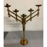 A pair of brass twisted candle sticks with two extendable brass candle arms holding five candles