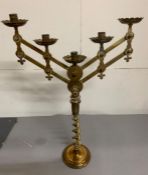 A pair of brass twisted candle sticks with two extendable brass candle arms holding five candles