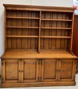 A double oak bookcase with cupboards under by Stewart Linford (H204cm W190cm D58cm)