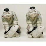 A pair of china sumo's wrestlers riding tortoise