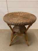 A wicker circular table on tier (H66cm Dia60cm)