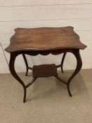 A mahogany side table with scalloped edge and under tier (H72cm W58cm D40cm)