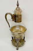 A silver plate and glass coffee/tea pitcher with footed warmer stand.
