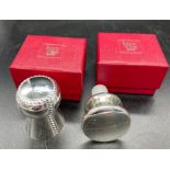 Two Roberts and Dore plated wine stoppers