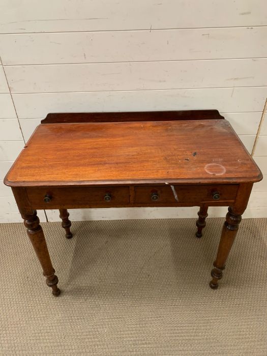 A mahogany wash stand on turn legs and drawers to centre AF (H79cm W90cm D49cm)Condition Report Chip