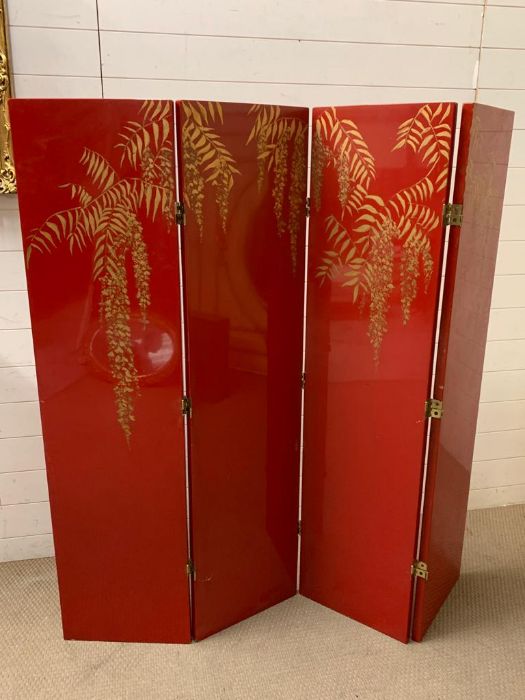 A signed four panel room divider or scren in a Chinese style on red grounds by Andrea Mart (1981)