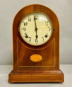 A Domed mahogany, with fruitwood inlay eight day mantle clock.