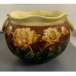 A jardinière pot with yellow and brown grounds