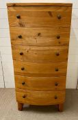 A tall pine bow fronted chest of six drawers with bun handles (H126cm W60cm D53cm)