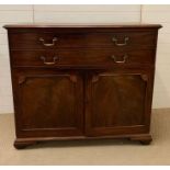 A secretary's chest with panel front doors and bracket feet (H112cm W126cm D56cm)