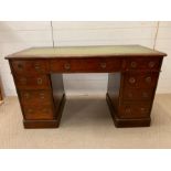 A pedestal desk with brass ring handles and leather top (H70cm W122cm D58cm)